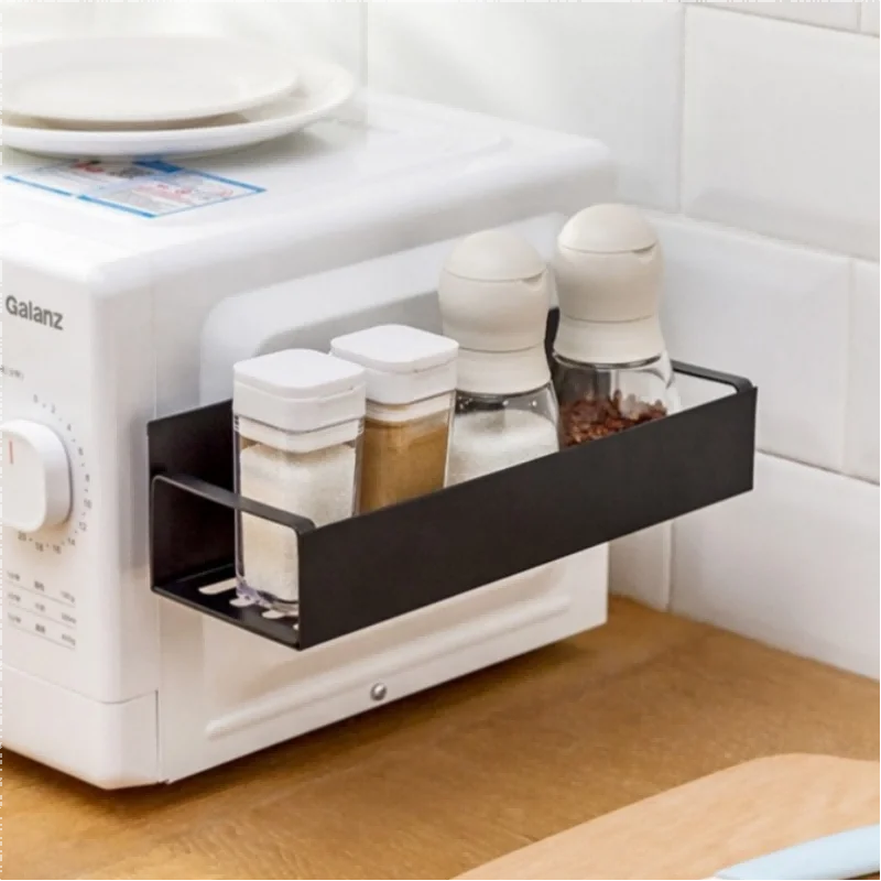 Kitchen countertop with a Galanz toaster and black storage tray holding various containers.