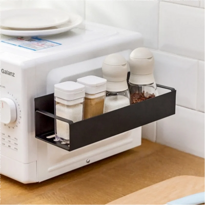 Kitchen countertop with a Galanz toaster and black storage tray holding various containers.