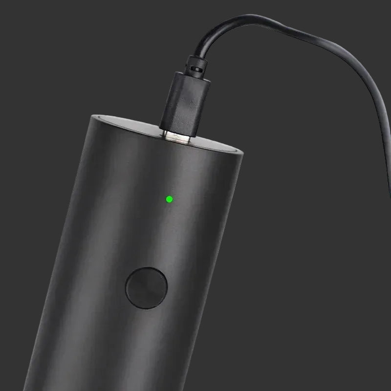 Black electronic device with a green indicator light on a white background