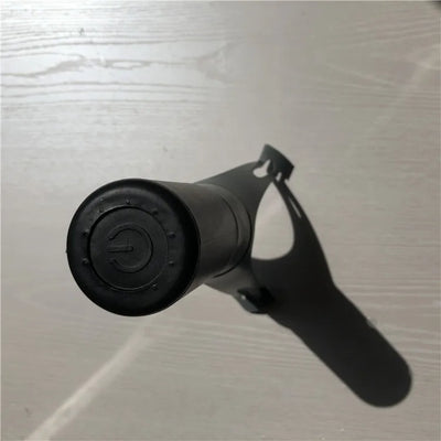 Black handheld device on a textured gray surface