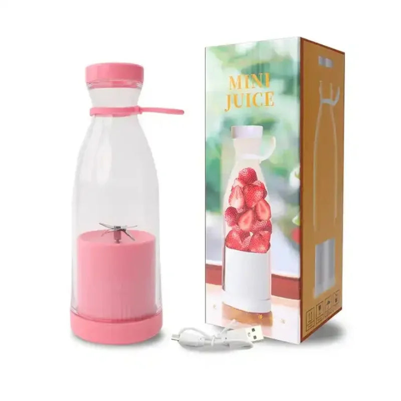 Pink and clear juice blender with packaging on a white background