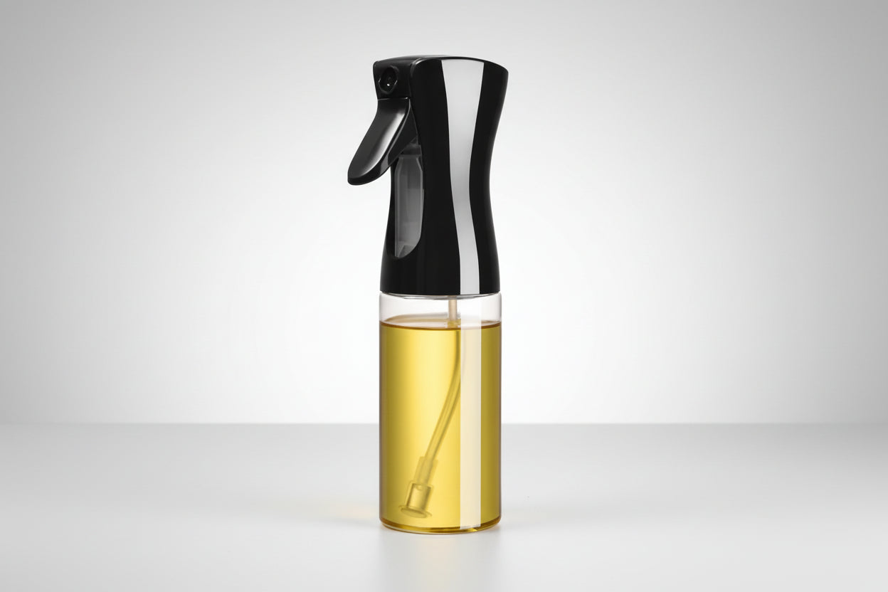 Spray bottle with black nozzle and clear body containing oil, labeled '300ml' on a white background.