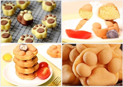A collection of freshly baked cat paw shaped waffles served on a plate with cream and fruit toppings.